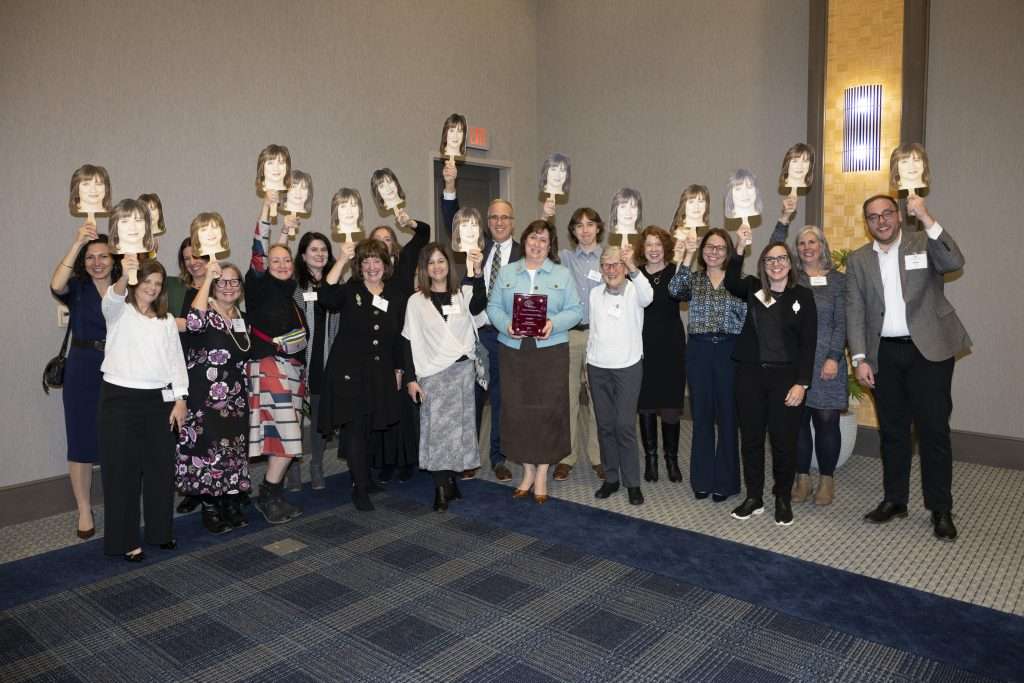 the team at the Food Bank with photo signs of Maureen at Advancement Advisors